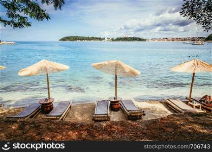 Sunshade and sunlounge on a beach, Lone Bay, Croatia