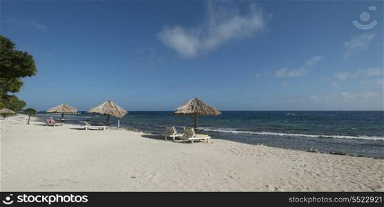 Sunshades with chairs on the beach, Utopia Village, Utila, Bay Islands, Honduras