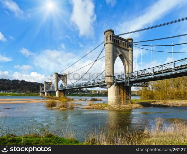 Sunshine above spension Bridge spanning the Loire in Langeais, France. Built between 1846 and 1849. Architect Phidias Vestier.