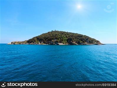 Sunshiny rocky sea coast of Tino island (with lighthouse and monastery ruins) near Portovenere (Gulf of Poets, Cinque Terre National Park, La Spezia, Liguria, Italy).
