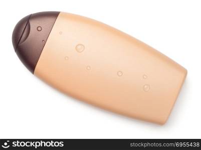 Suntan cream bottle with water drops isolated on white background. Top view