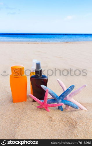 suntun lotions on sandy beach by sea side