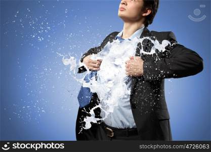 Super businessman. Businessman in suit tearing his shirt on chest
