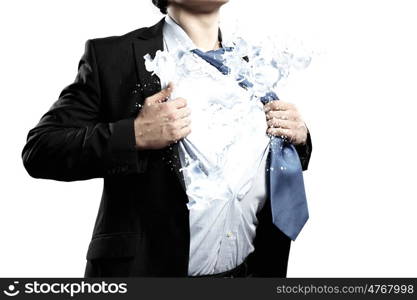 Super businessman. Businessman in suit tearing his shirt on chest