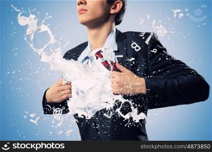 Super businessman. Businessman in suit tearing his shirt on chest