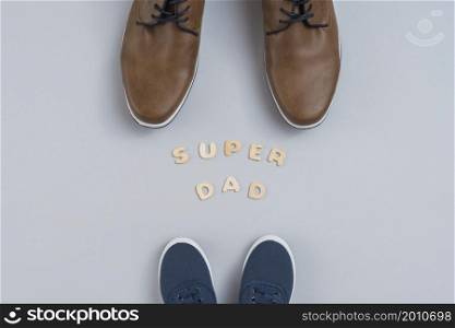 super dad inscription with man children shoes