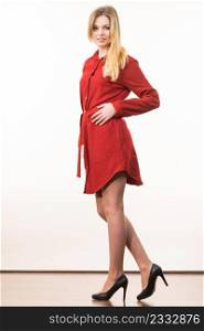 Super fashionale woman wearing elegant casual red short dress and black stylish high heels.. Woman wearing elegant casual red dress