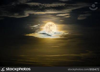 Super full moon on the yellow sky at midnight, golden moonlight reflect the cloud, Beautiful nature landscape view at night scene for background. Full moon on the golden sky at night