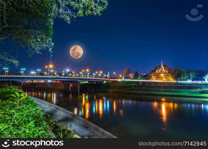 Super Full Moon over Pagoda on the Temple That is a tourist attraction, Phitsanulok, Thailand. February 2019 at night