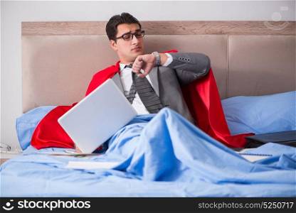 Super hero businesswoman working in bed