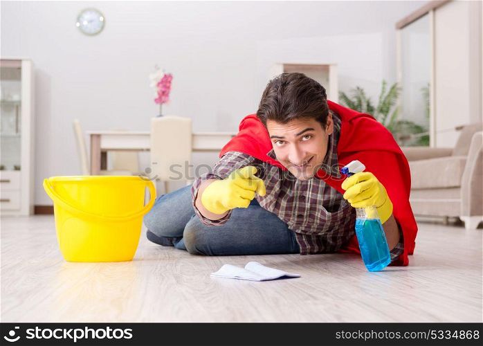 Super hero husband cleaning floor at home
