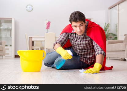 Super hero husband cleaning floor at home