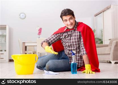 Super hero husband cleaning floor at home