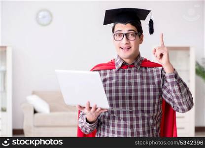 Super hero student wearing mortarboard and holding a laptop