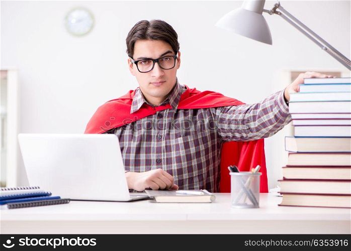 Super hero student with a laptop studying preparing for exams