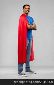 super power and people concept - happy smiling indian man in red superhero cape with crossed arms over grey background. happy smiling indian man in red superhero cape