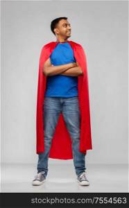 super power and people concept - happy smiling indian man in red superhero cape with crossed arms over grey background. happy smiling indian man in red superhero cape