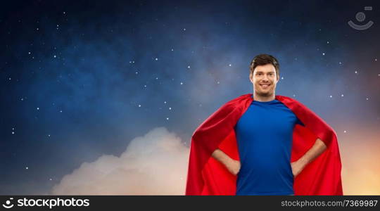 super power and people concept - happy young man in red superhero cape over starry night sky background. man in red superhero cape over night sky