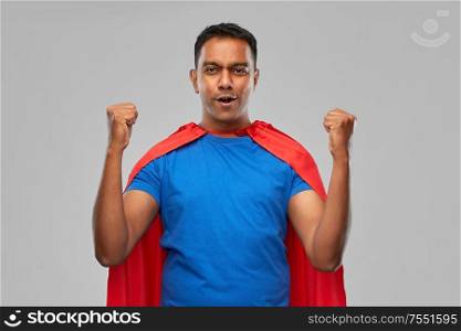 super power and people concept - indian man in red superhero cape making winning gesture over grey background. indian man in superhero cape makes winning gesture