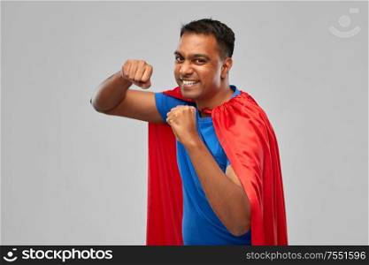 super power and people concept - indian man in red superhero cape making winning gesture over grey background. indian man in superhero cape makes winning gesture