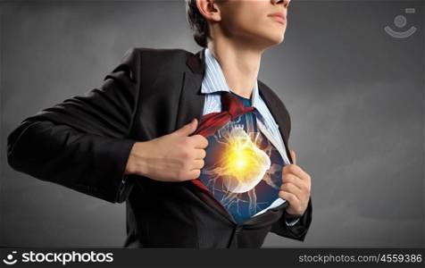 Super professional. Businessman opening his shirt on chest acting like super hero