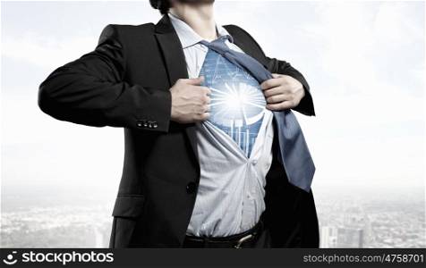 Super professional. Businessman opening his shirt on chest acting like super hero