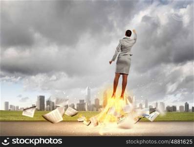 Super woman. Image of businesswoman flying up into sky