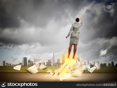 Super woman. Image of businesswoman flying up into sky