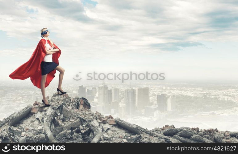 Super woman. Young confident woman in red cape and mask