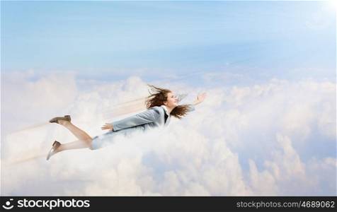Super woman. Young happy businesswoman flying high in sky