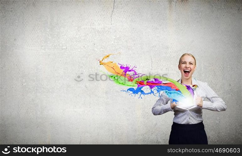 Super woman. Young woman tearing shirt on chest and splashes flying out