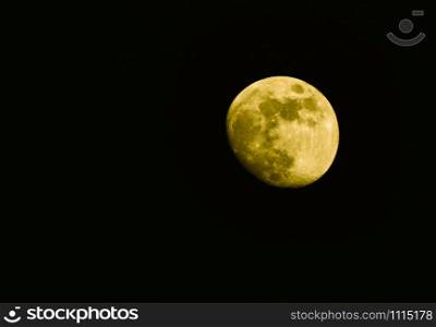 Super yellow moon isolated on black background - Real moon on dark night sky selective focus