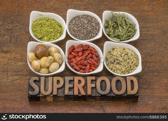 superfood abstract (matcha green tea, chia seeds, stevia herb, macadamia nuts, goji berry and hemp seed hearts) with a text in vintage letterpress wood type