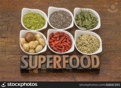 superfood abstract (matcha green tea, chia seeds, stevia herb, macadamia nuts, goji berry and hemp seed hearts) with a text in vintage letterpress wood type