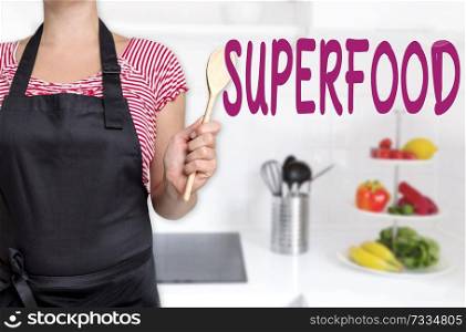 superfood cook holding wooden spoon concept background.. superfood cook holding wooden spoon concept background