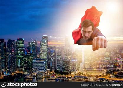 Superhero businessman flying over the city