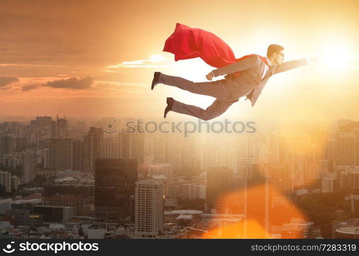 Superhero businessman flying over the city