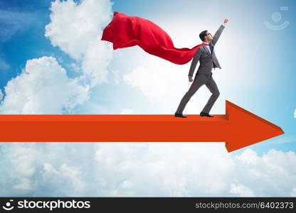 Superhero businessman standing on arrow