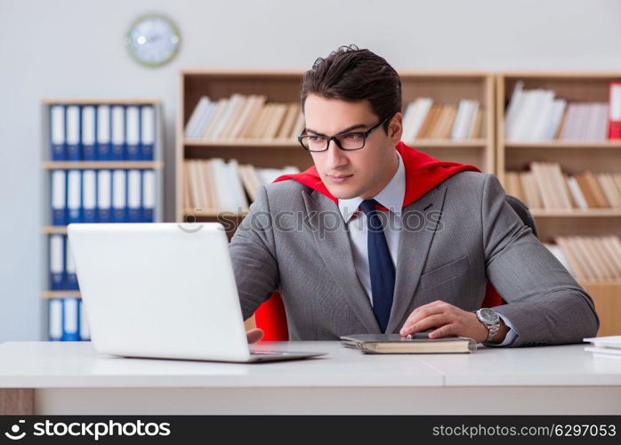 Superhero businessman working in the office