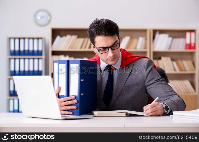 Superhero businessman working in the office