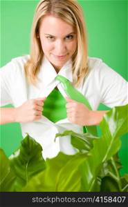 Superhero Businesswoman confident face green plants emerges from shirt
