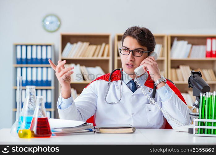 Superhero doctor working in the hospital lab