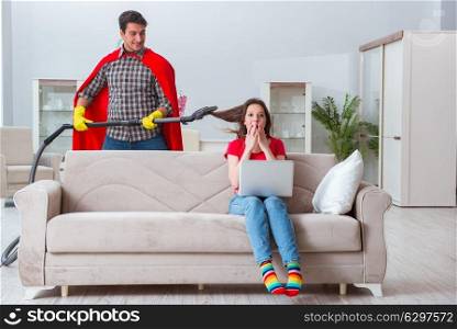 Superhero husband helping his wife at home