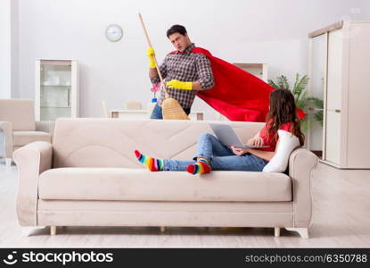 Superhero husband helping his wife at home