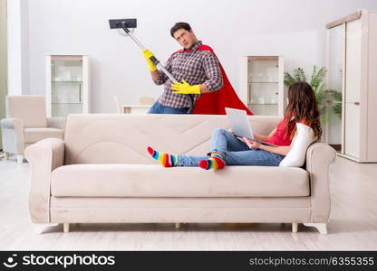 Superhero husband helping his wife at home