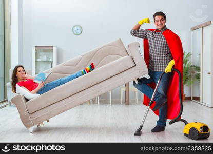 Superhero husband helping his wife at home