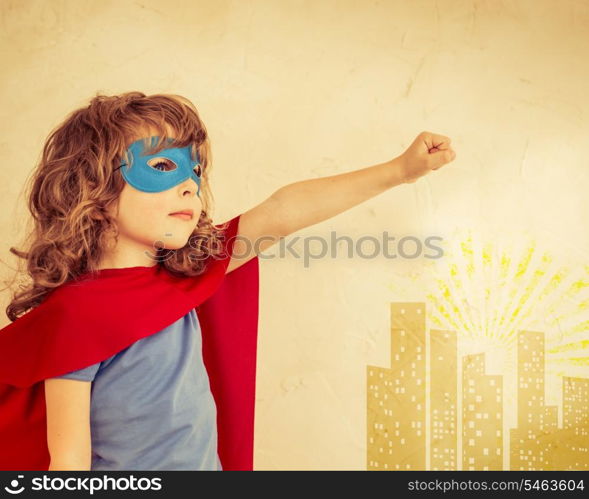 Superhero kid against grunge wall background