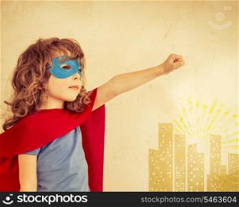 Superhero kid against grunge wall background