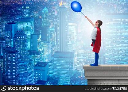 Superhero kid holding air balloon