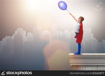 Superhero kid holding air balloon